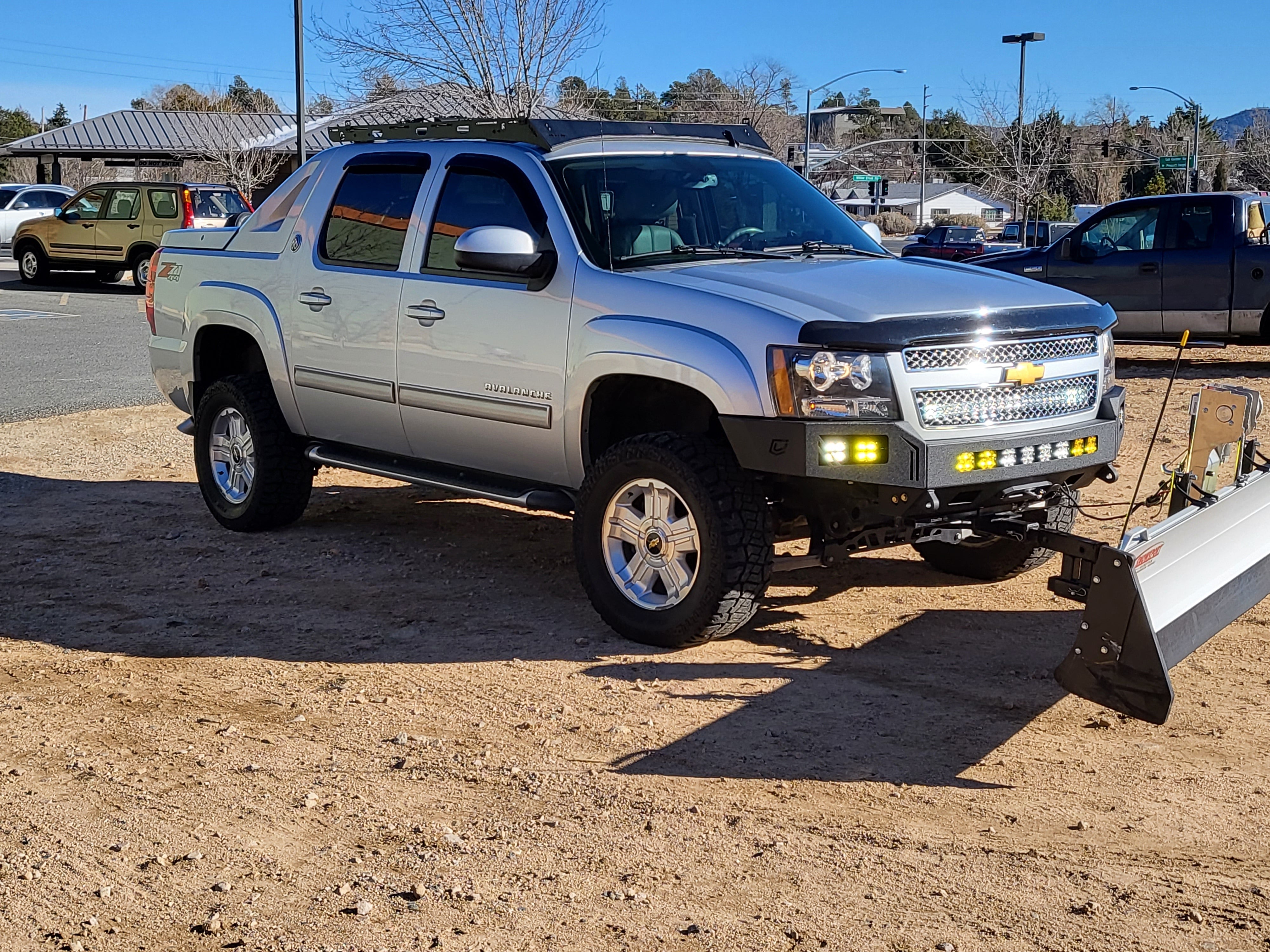 Reliable 2007-2014 Chevrolet Avalanche roof rack with Baseline Overland, winch bumper, baja designs squadron sport and snow plow